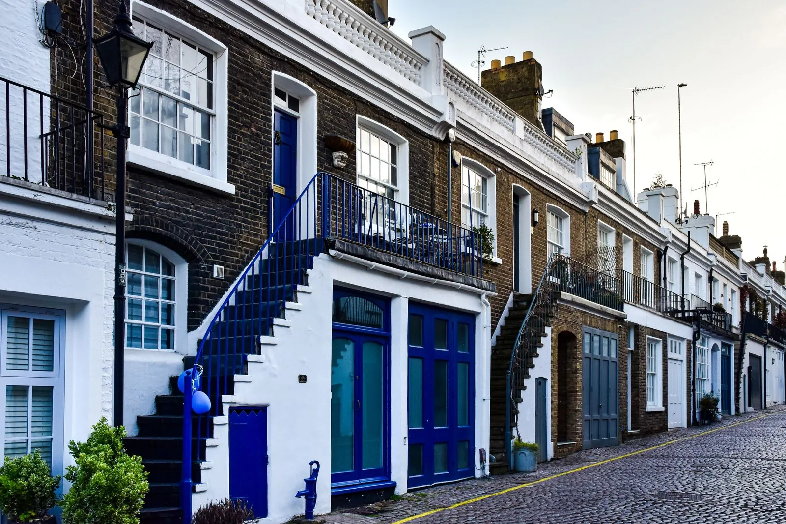 Row of brick terraced houses in a UK street