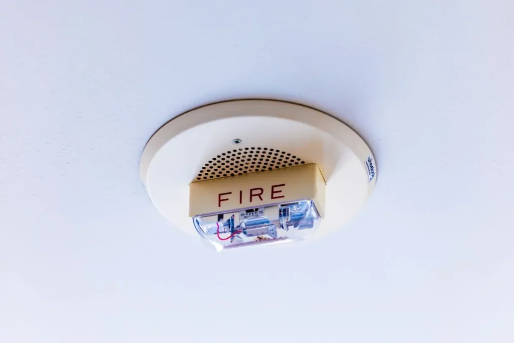White smoke alarm fitted to a ceiling